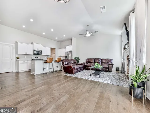 a living room with furniture and kitchen view