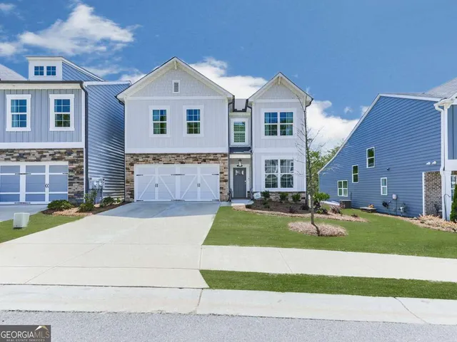 a front view of a house with a yard and garage