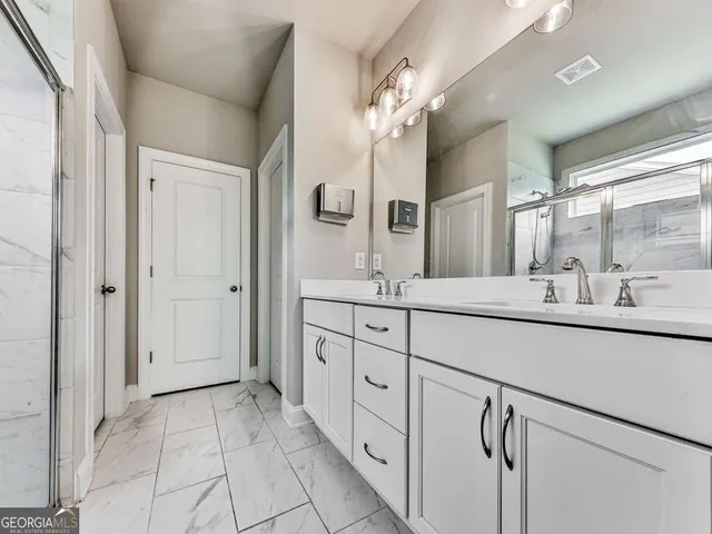 a spacious bathroom with a double vanity sink mirror and