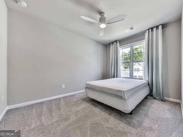 a spacious bedroom with a bed and a window