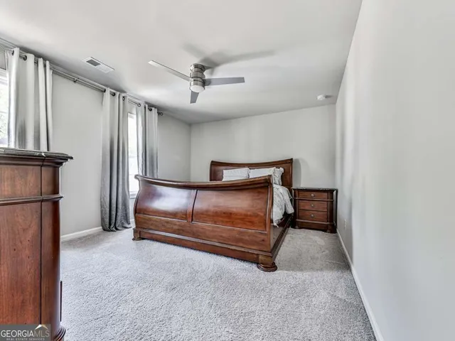 a bedroom with furniture and a ceiling fan