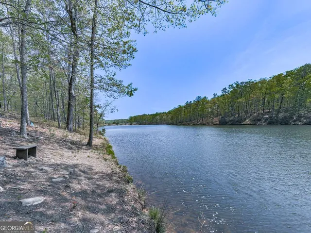 a view of a lake next to a yard