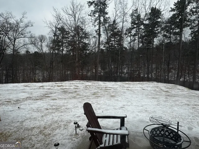 a backyard of a house with table and chairs