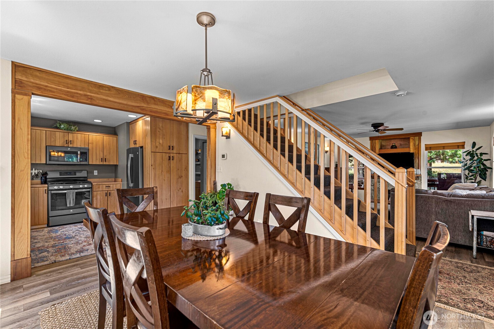 17558 River Road Leavenworth, WA 98826 - Photo 17 of 35 a dining room with furniture a chandelier and wooden floor