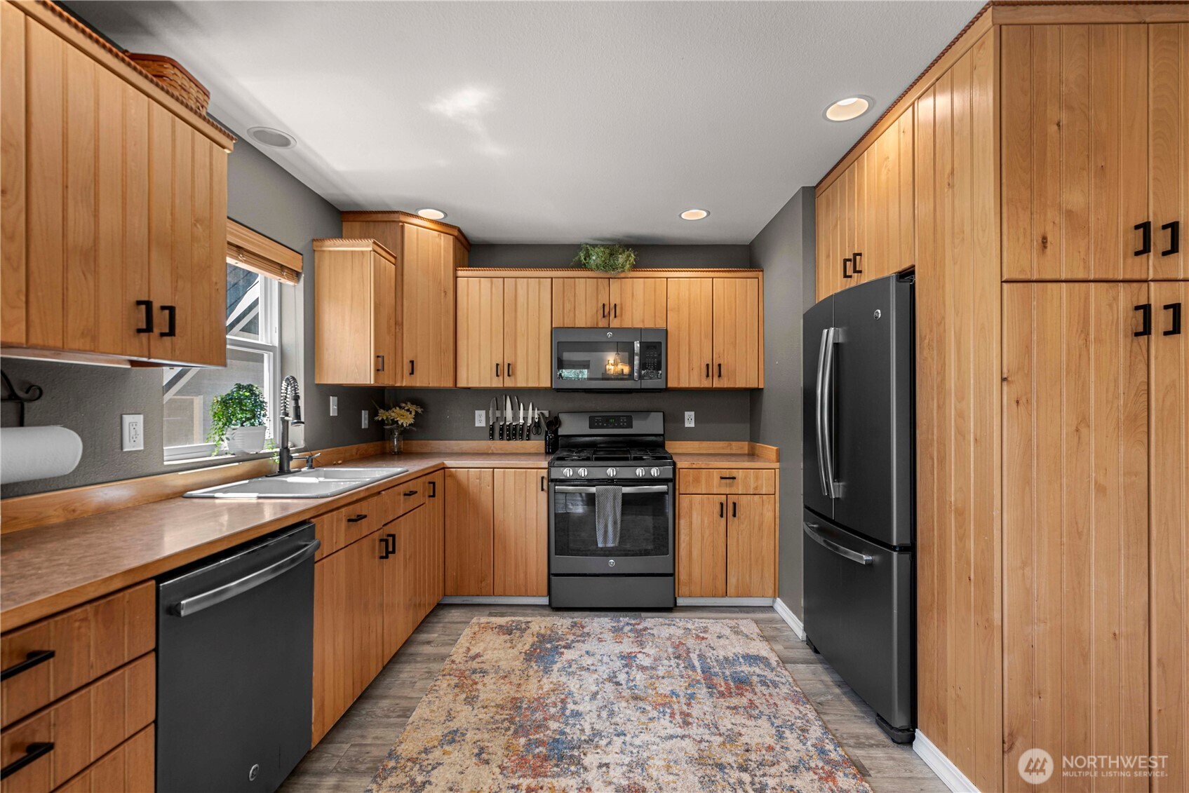 17558 River Road Leavenworth, WA 98826 - Photo 18 of 35 a kitchen with stainless steel appliances granite countertop a refrigerator a sink dishwasher a stove top oven a refrigerator and cabinets