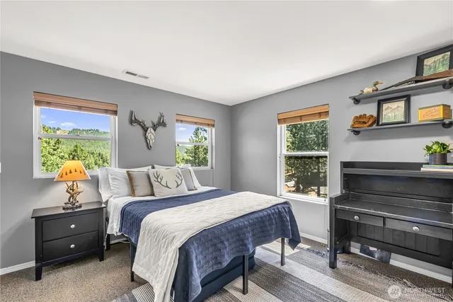 a bedroom with a bed and a window