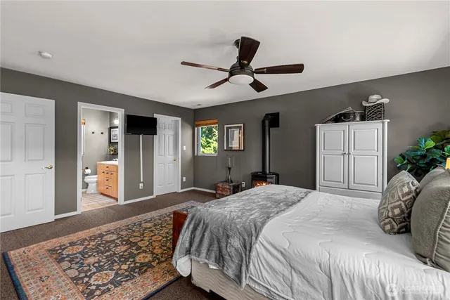 a bedroom with a large bed and a dresser