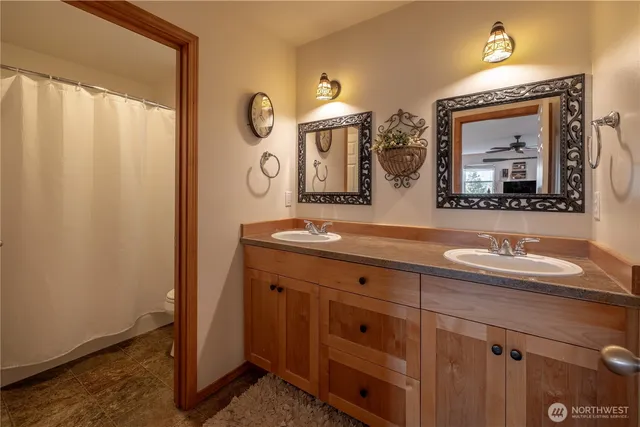 a bathroom with a double vanity sink and a mirror