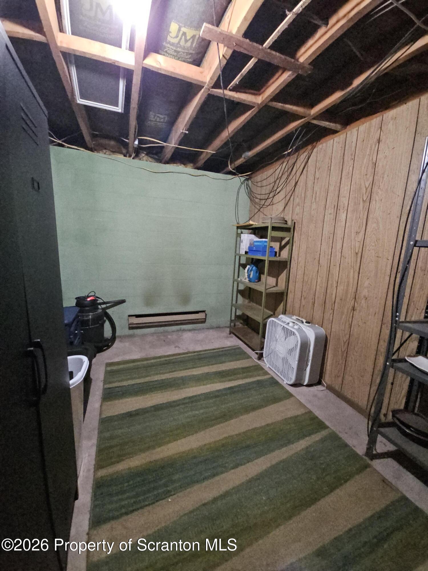 405 Baker Street Taylor, PA 18517 - Photo 32 of 36 a bedroom with a bed and a rug