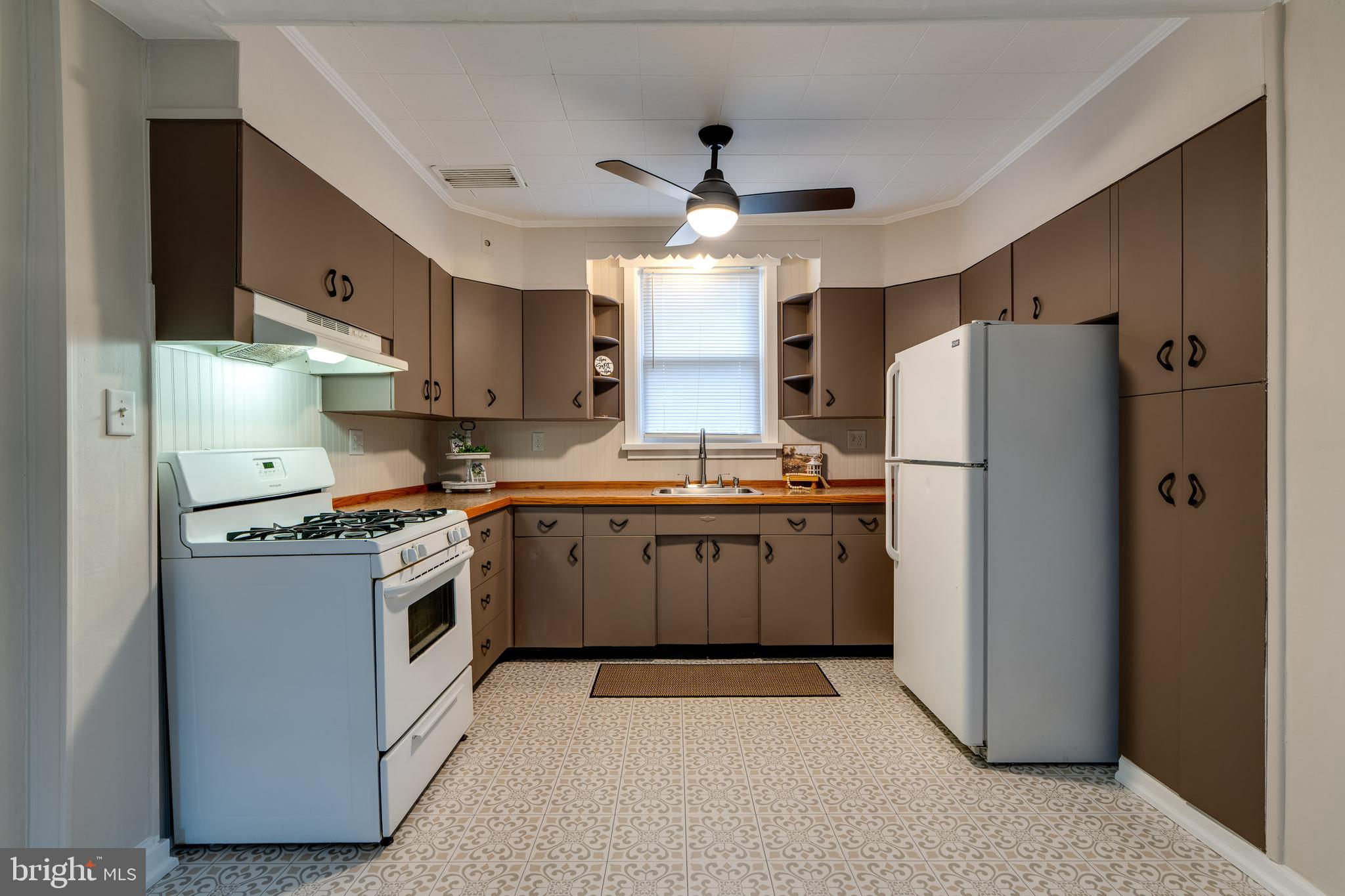 609 Lawn Reading, PA 19609 - Photo 14 of 34 a kitchen with a refrigerator a stove top oven a sink and dishwasher