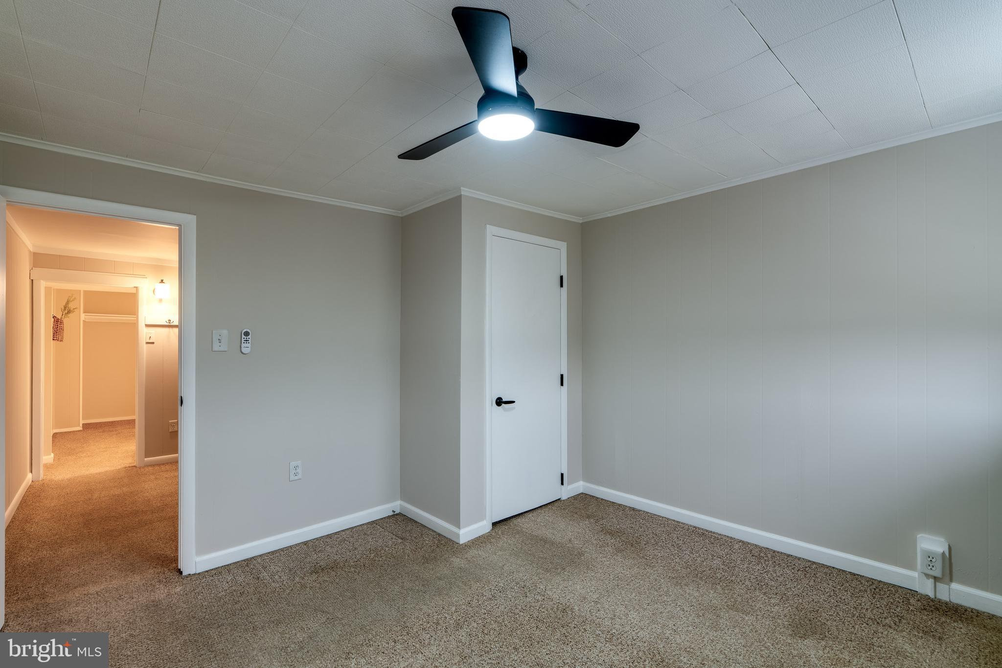 609 Lawn Reading, PA 19609 - Photo 22 of 34 an empty room with a ceiling fan and carpet
