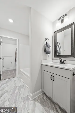 a bathroom with a sink and mirror