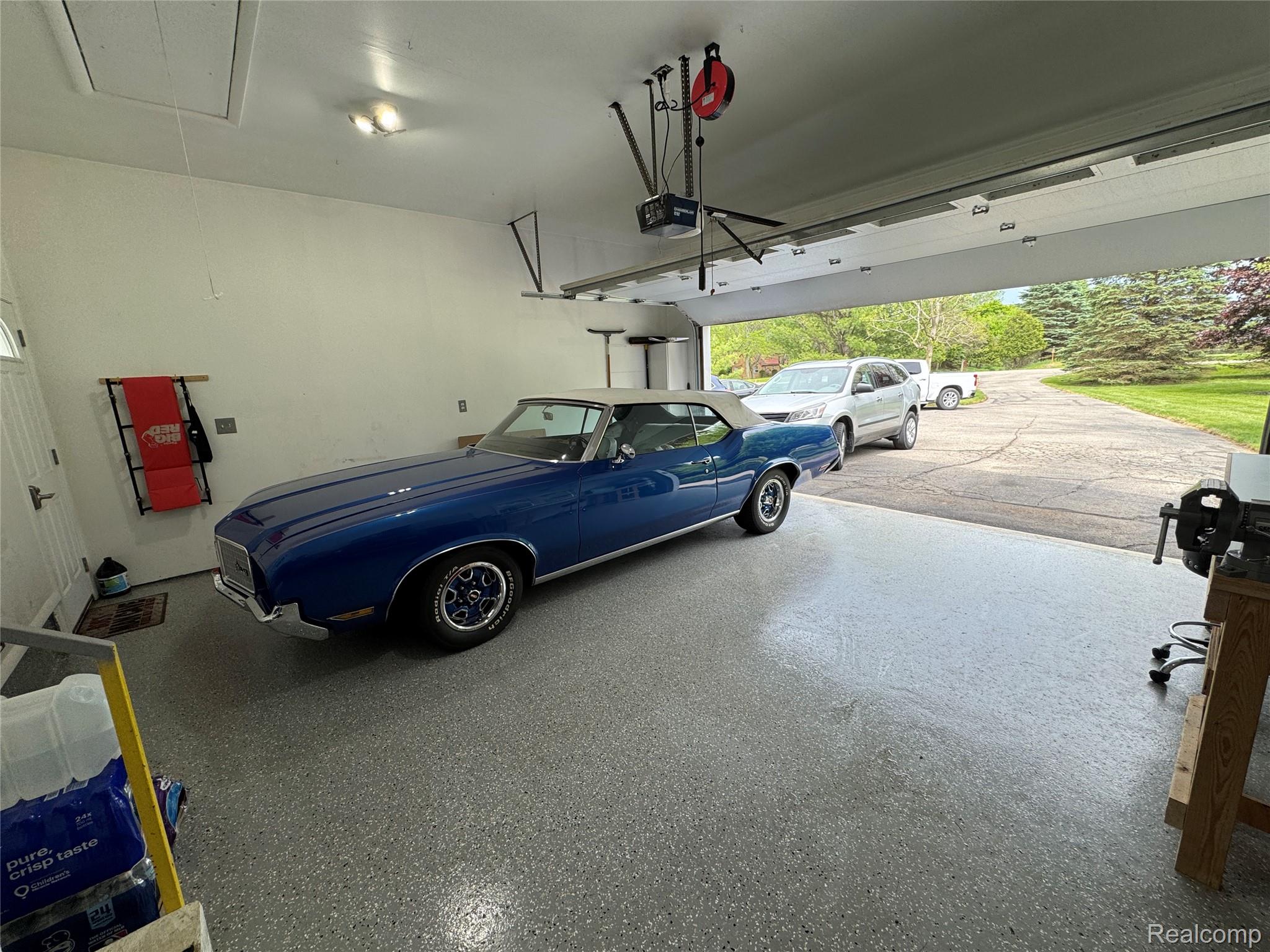 5183 North Owosso Road Fowlerville, MI 48836 - Photo 25 of 27 Garage featuring a garage door opener