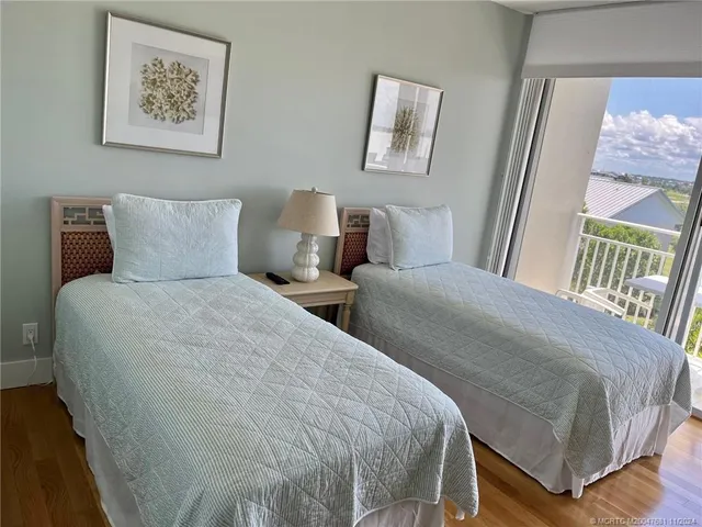 a bedroom with double bed and a painting on the wall