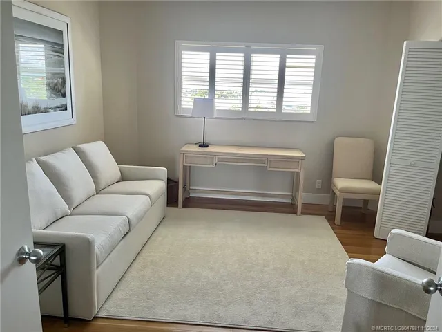 a living room with furniture a couch and a window