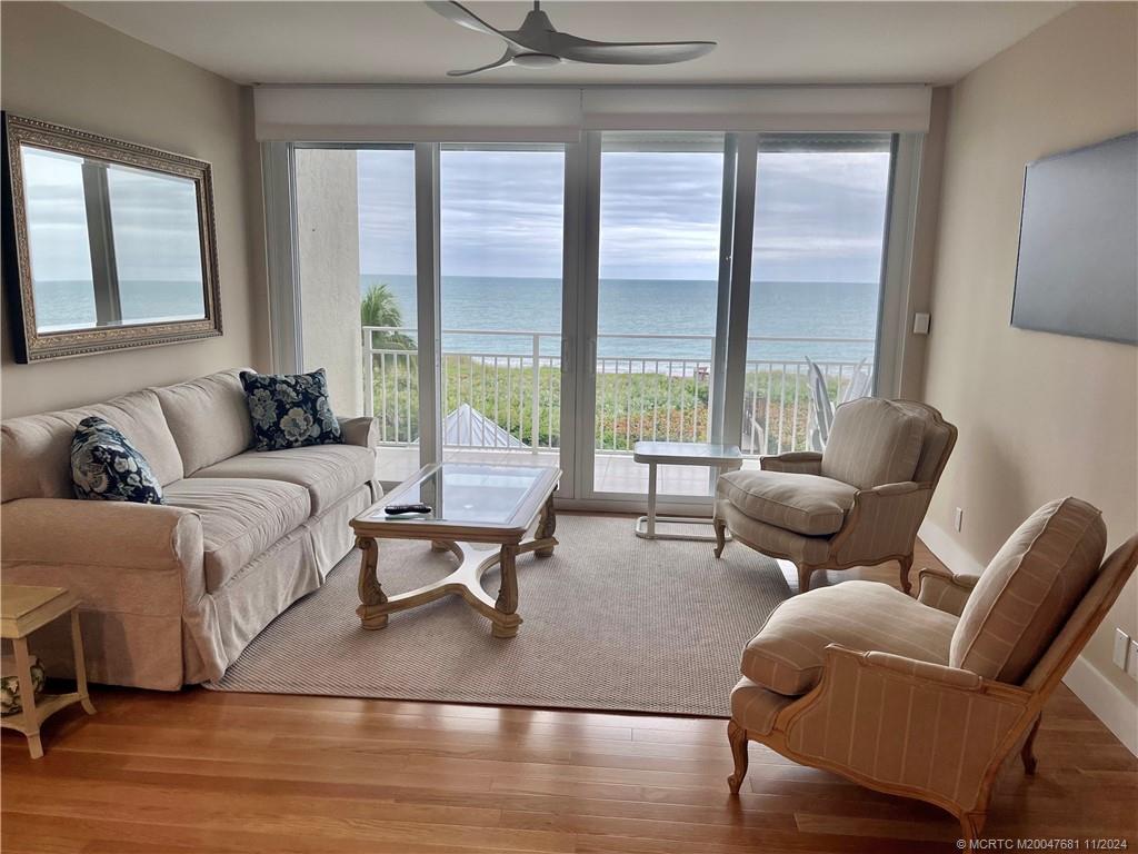 579 Northeast Plantation Road, Unit 301N Jensen Beach, FL 34957 - Photo 3 of 15 a living room with furniture and a large window