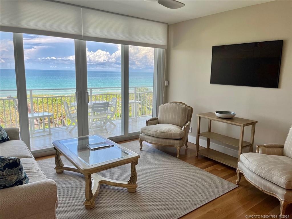 579 Northeast Plantation Road, Unit 301N Jensen Beach, FL 34957 - Photo 4 of 15 a living room with furniture and a flat screen tv