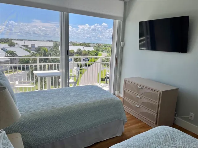 a bedroom with a bed and a television