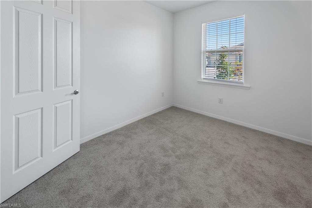 1093 Tranquil Brook Drive Naples, FL 34114 - Photo 13 of 22 an empty room with windows
