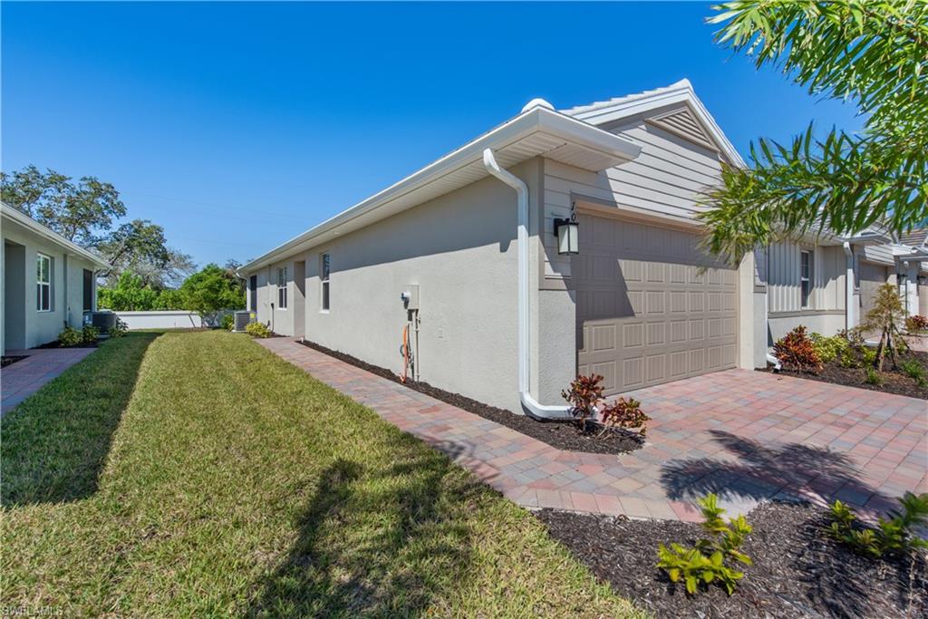 1093 Tranquil Brook Drive Naples, FL 34114 - Photo 3 of 22 a view of backyard with a garden and car parked