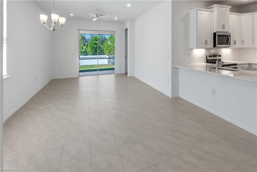 1093 Tranquil Brook Drive Naples, FL 34114 - Photo 4 of 22 a view of kitchen with livingroom