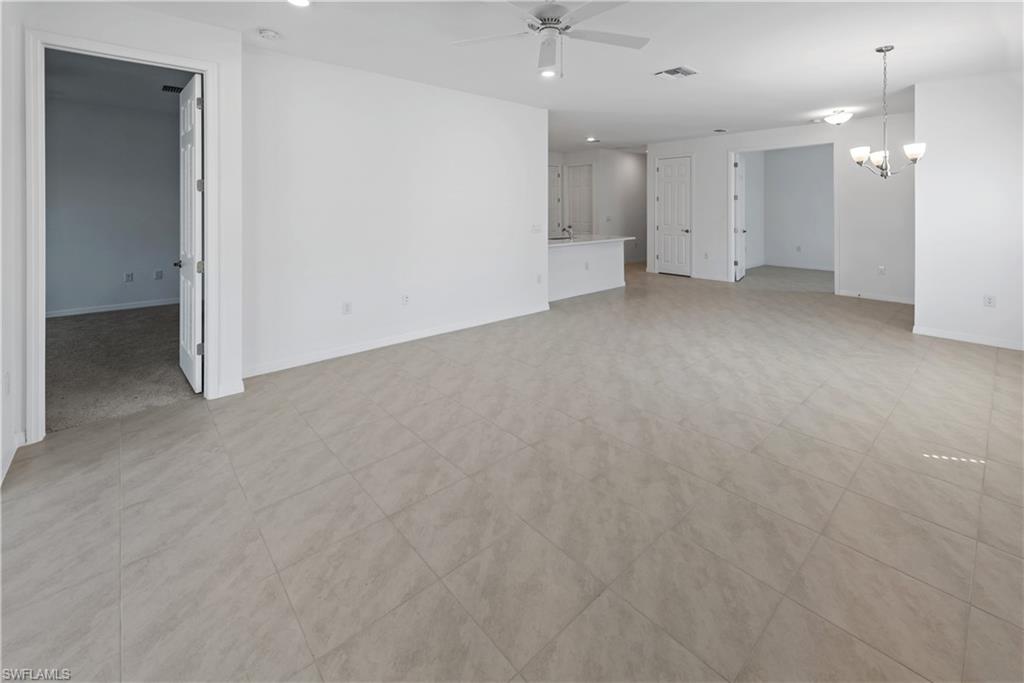 1093 Tranquil Brook Drive Naples, FL 34114 - Photo 5 of 22 an empty room with a kitchen and a sink