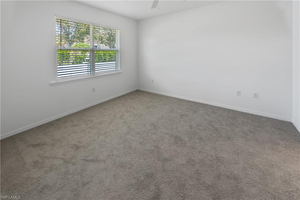 1093 Tranquil Brook Drive Naples, FL 34114 - Photo 9 of 22 an empty room with a window