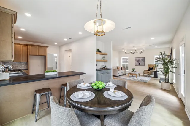 a bathroom with a granite countertop toilet sink and mirror