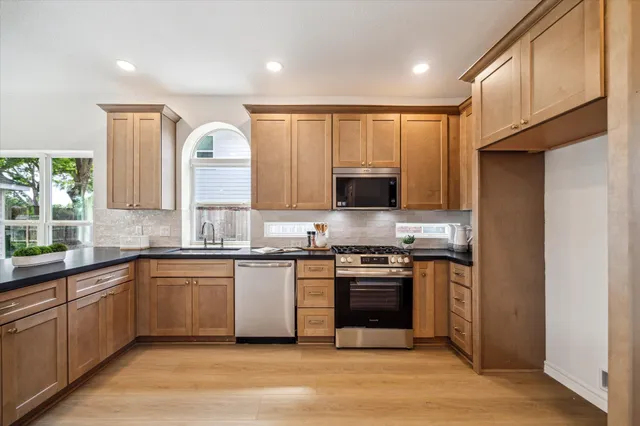 a living room with furniture a fireplace and a chandelier