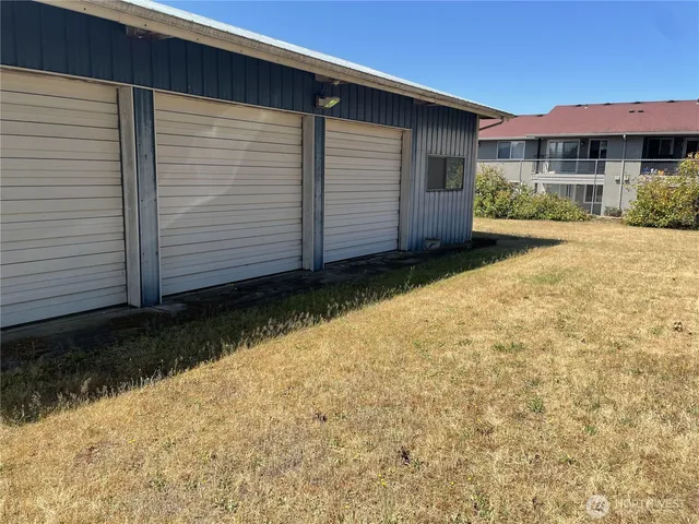 a view of a yard covered with snow in front of house