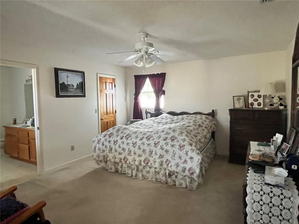 14182 Southwest 161st Street Brooker, FL 32622 - Photo 15 of 20 a bedroom with bed and window