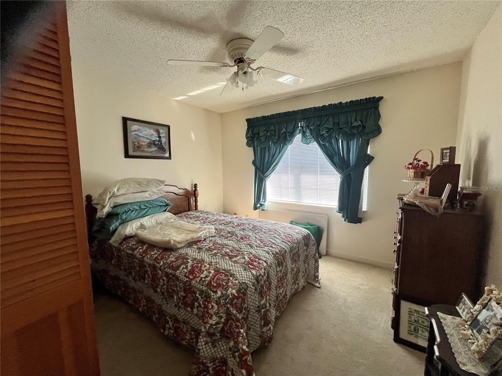 14182 Southwest 161st Street Brooker, FL 32622 - Photo 17 of 20 a bedroom with a bed mirror and window