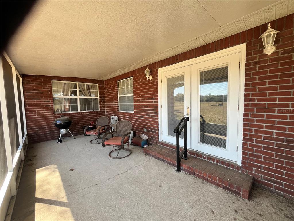 14182 Southwest 161st Street Brooker, FL 32622 - Photo 19 of 20 a view of a patio with chairs and tables