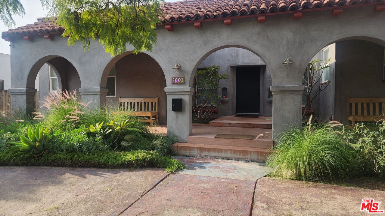 3003 Vineyard Avenue Los Angeles, CA 90016 - Photo 3 of 6 a front view of a house with garden
