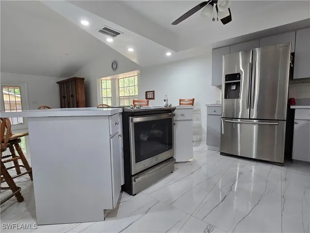 a kitchen with cabinets and stainless steel appliances
