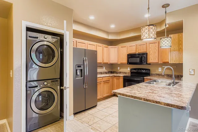 a kitchen with a sink a stove top oven and refrigerator