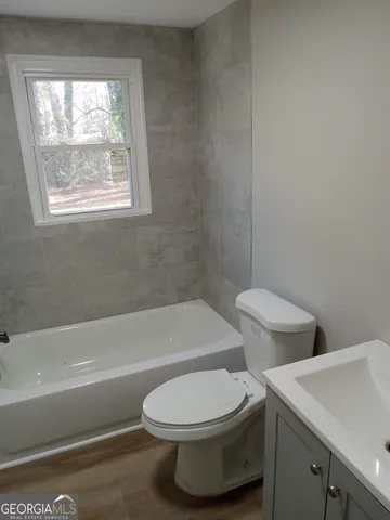 a bathroom with a toilet a sink and bath tub