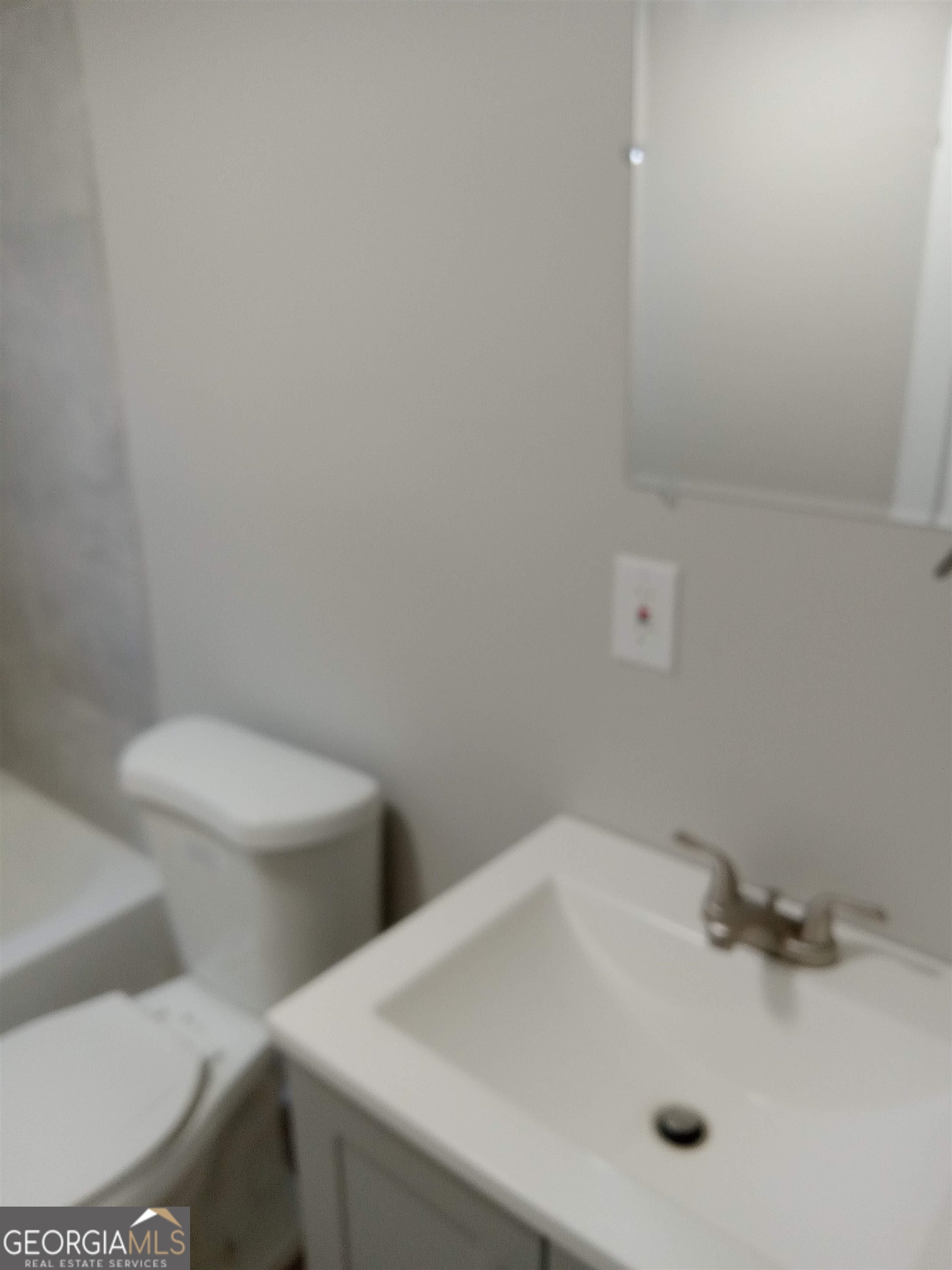 1186 Eastview Road Northeast Conyers, GA 30012 - Photo 12 of 20 a bathroom with a sink and a toilet