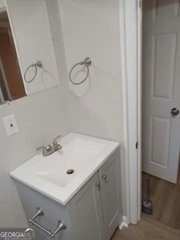 a bathroom with a sink and mirror