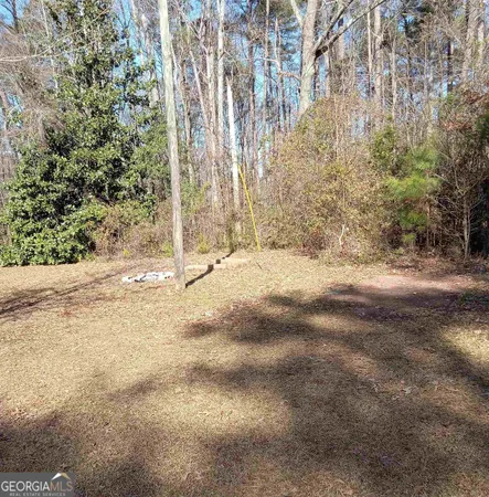 a view of a yard with trees