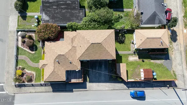 an aerial view of multiple houses with yard