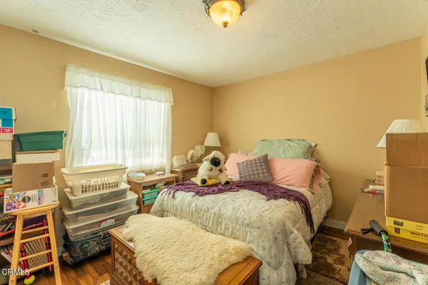 a bed room with a bed and a chair