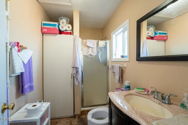 a bathroom with a sink vanity mirror and toilet