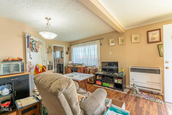a living room with furniture a flat screen tv and a window