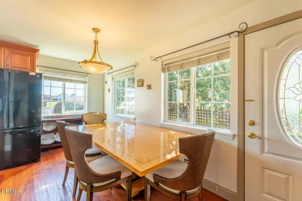 a dining room with furniture a chandelier and wooden floor
