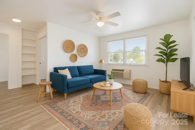a living room with furniture and a potted plant