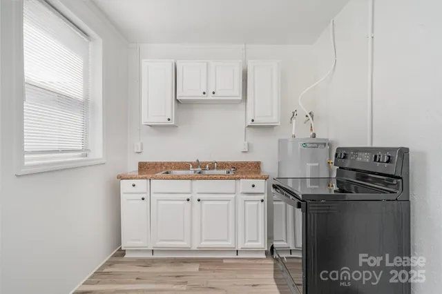 a kitchen with stainless steel appliances a refrigerator and a stove top oven