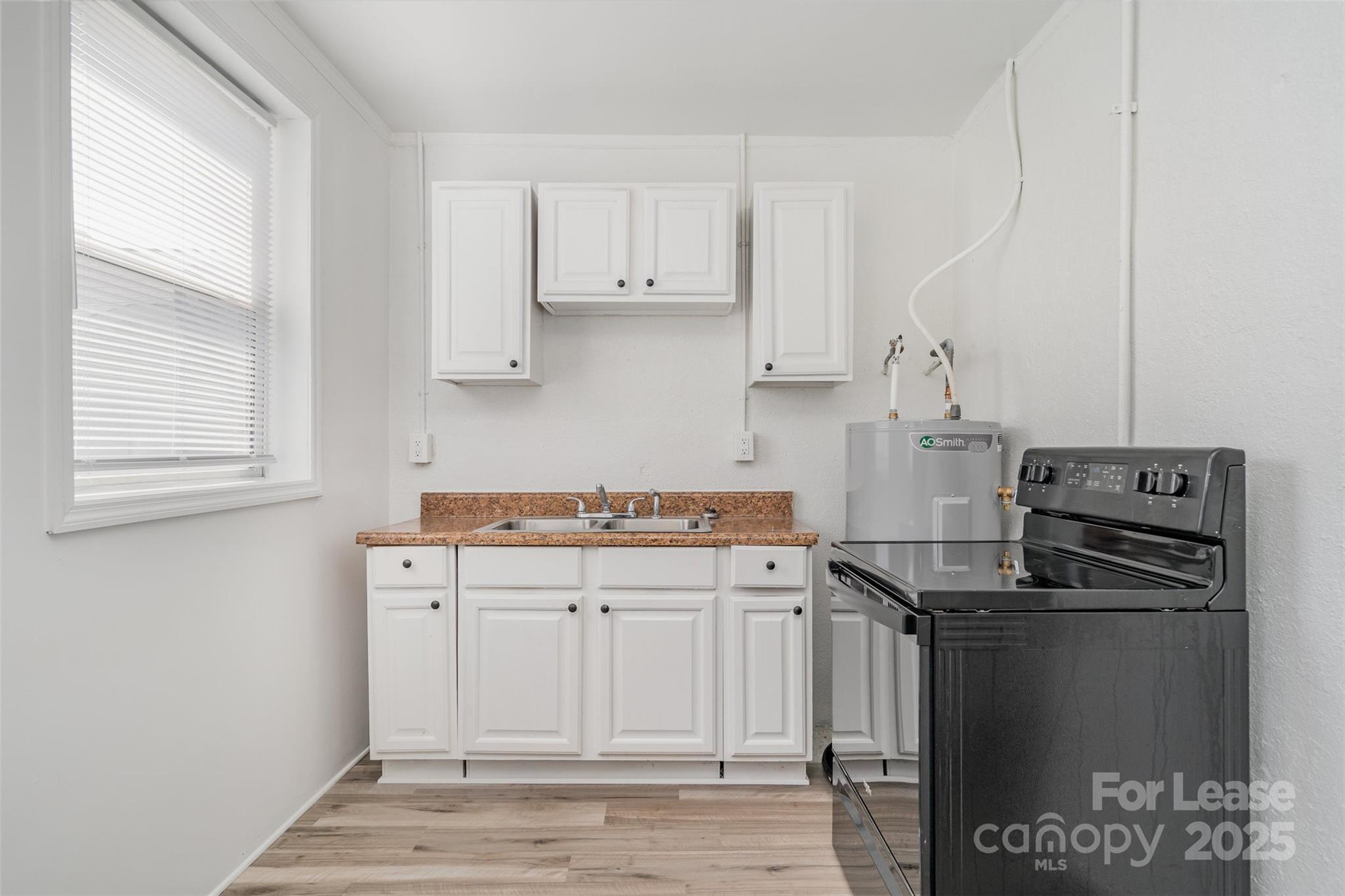200 York Street, Unit F2 Chester, SC 29706 - Photo 6 of 16 a kitchen with stainless steel appliances a refrigerator and a stove top oven