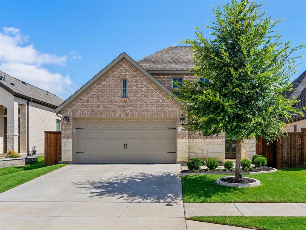 166 Palo Duro Bend Rhome, TX 76078 - Photo 2 of 40 Front elevation of 166 Palo Duro Bend in Rhome, Texas, featuring attractive curb appeal and a well-maintained exterior.