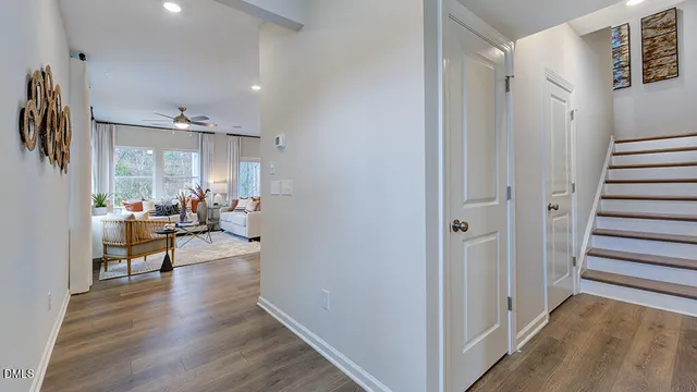 a living room with furniture a refrigerator and kitchen view